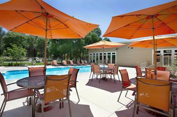 Swimming pool area with shaded chairs